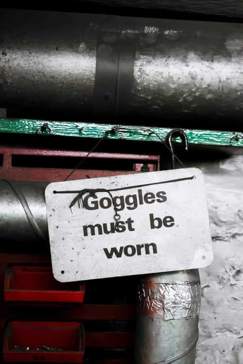 Safety Goggles Must Be Worn Signed Near Plumbing Work Site